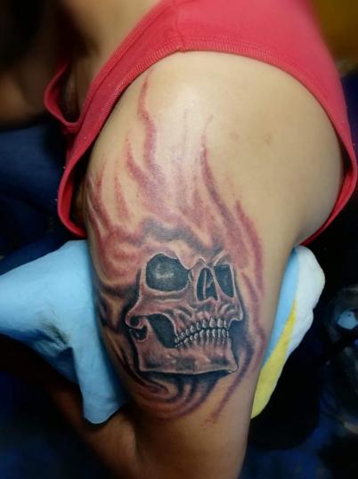 cráneo en llamas tatuaje realizado por Juliio Tatuajes